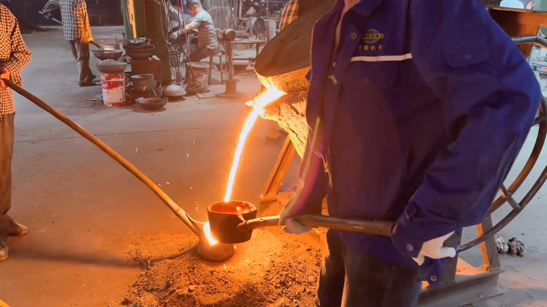 workers pour molten iron into casting machines