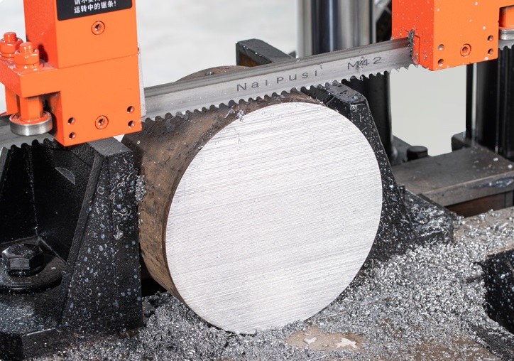 bandsaw cutting a cylindrical metal rod