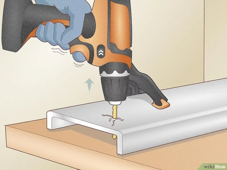 reverse the drill bit out from the metal