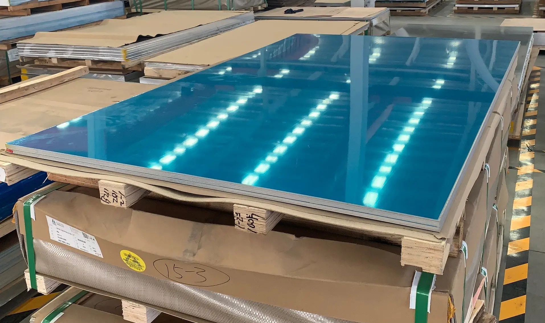 5052 aluminum alloy sheets in a factory warehouse 5052 aluminum plates with blue protective film stacked on pallets