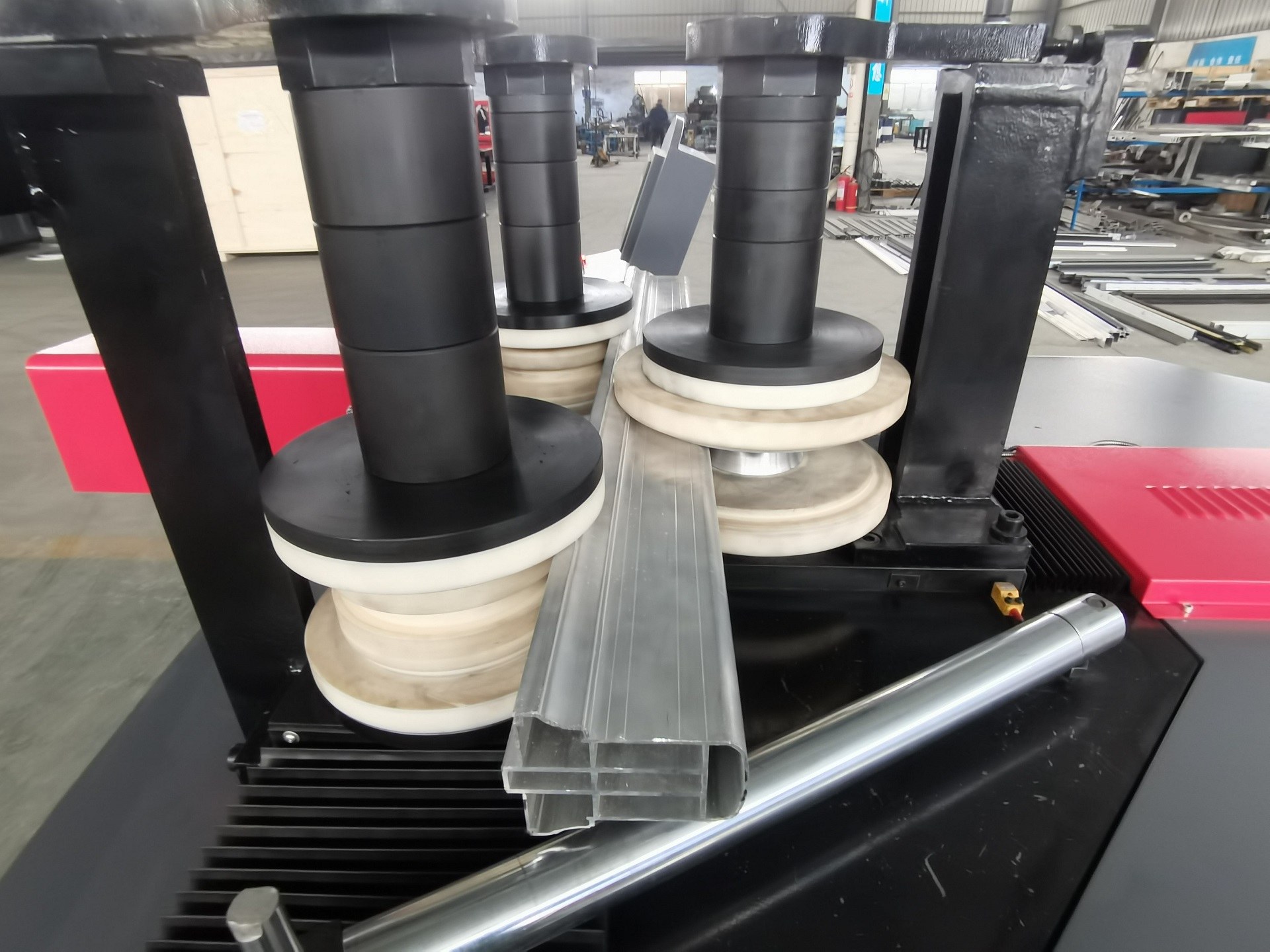 aluminum profile being bent by a multi roller bending machine