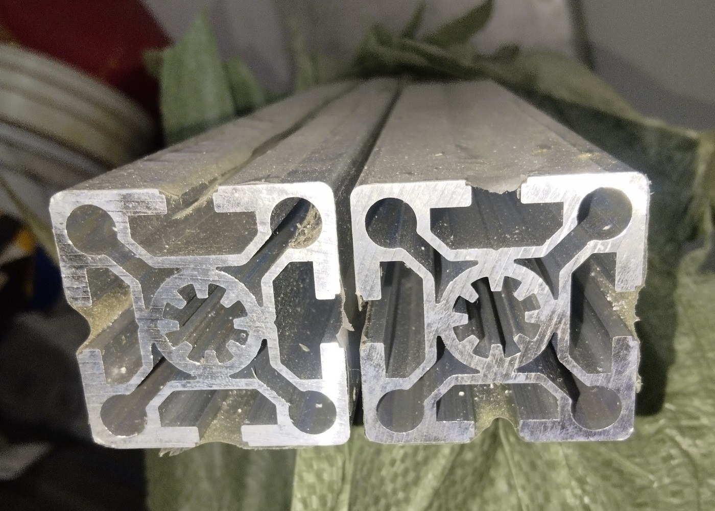 two aluminum profiles with intricate internal cross section designs