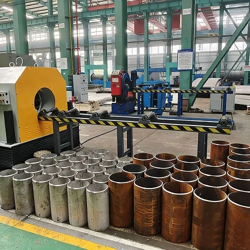 pcm series stationary pipe cutting and beveling machine in workshop with finished pipes