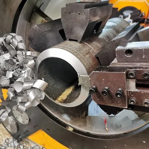 pipe cutting and beveling process with metal chips flying off thick wall steel pipe