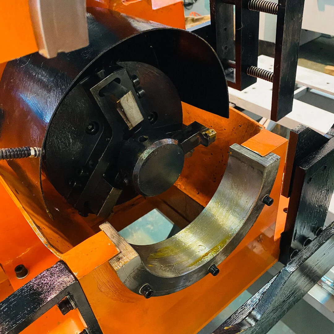 close up of double head chamfering machine machining head showing 3 jaw chuck and innerouter chamfering tools