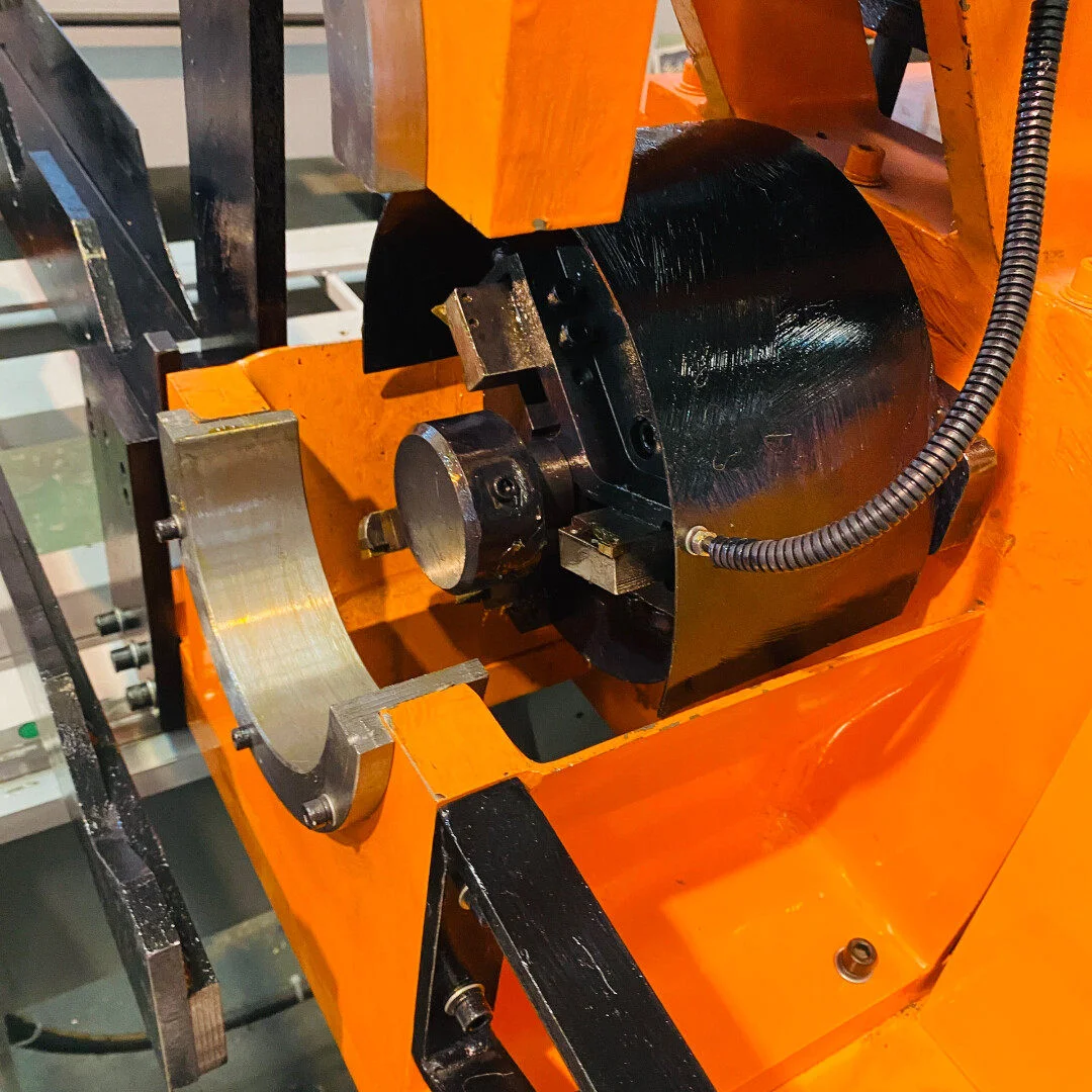 close up of double head chamfering machine machining station showing workpiece clamping and chamfering execution structure
